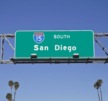San Diego 15 Freeway sign with palm trees.